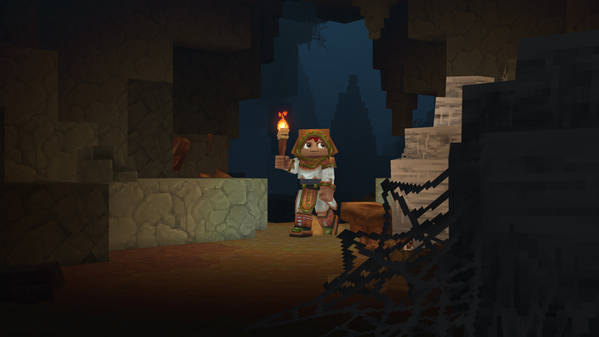 Player exploring a cave with a torch